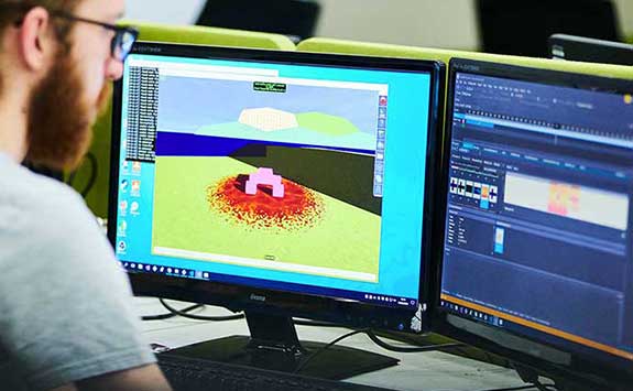 A computing student working in Computer Game Engineering in one of our Computing labs. 